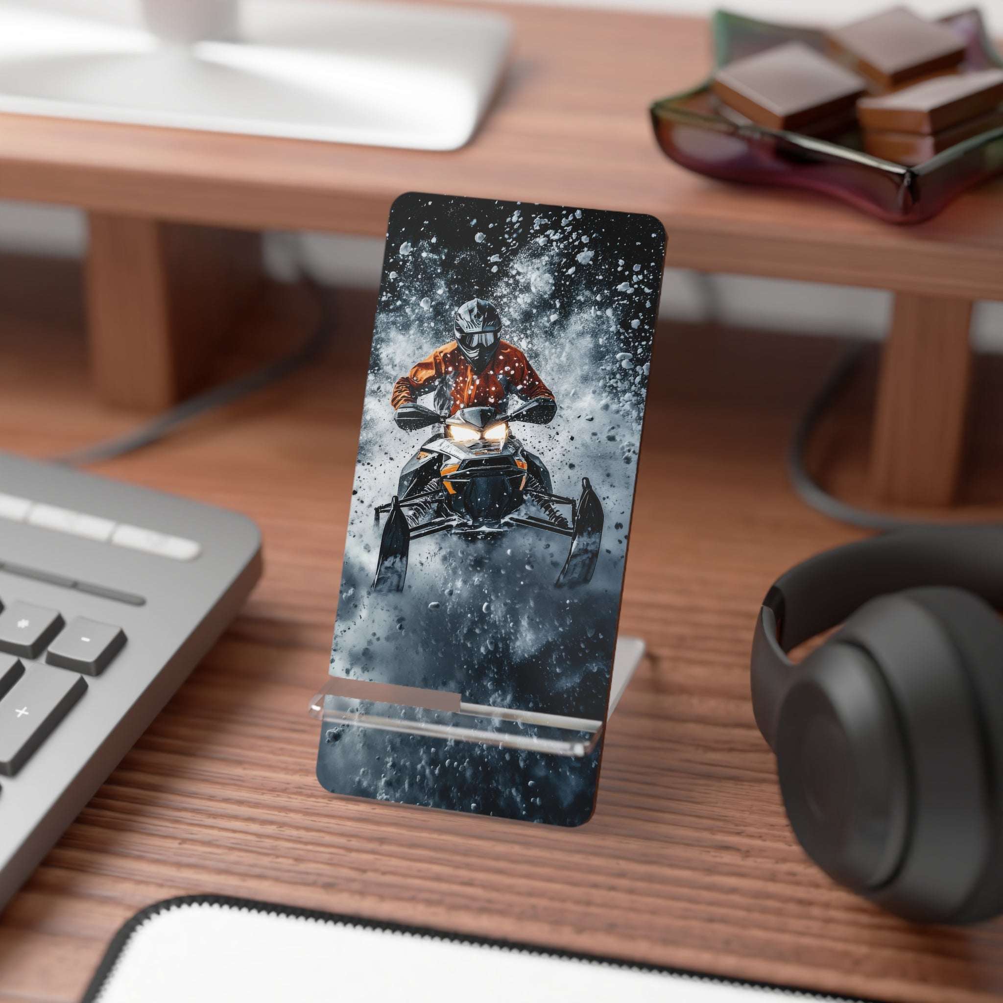 Snowsplosion Mobile display stand for smartphones, rider on a snowmobile busting through a snowbank
